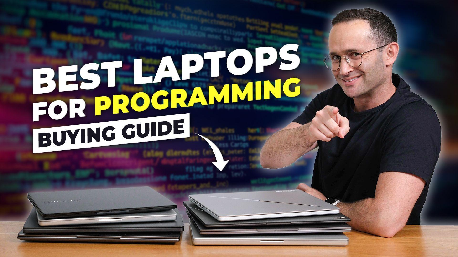 Josh pointing at the camera in front of a bunch of our favorite programming laptops with text reading "Best Laptops for Programming Buying Guide"